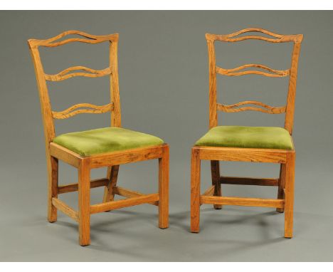 A pair of 19th century elm ladder back chairs, and a rush seated Country Kitchen chair.