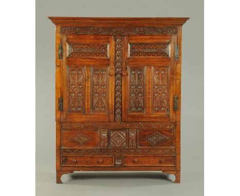 A 17th century oak press cupboard, dated 1669 and with the initial "TMB".  This cupboard was apparently made for a member of 