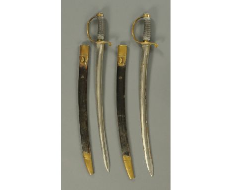 A pair of 1796 pattern Naval hangers, with brass handles and shagreen grips, each with leather and brass mounted scabbard, on