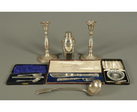 A cased set of fish servers, pair of plated candlesticks, cocktail shaker, soup ladle, etc. 