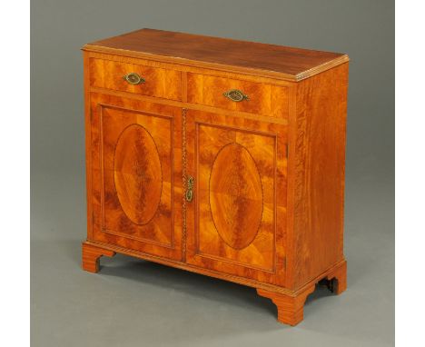 A late Victorian satinwood side cabinet, fitted with two drawers with brass drop handles and with a pair of cupboard doors wi