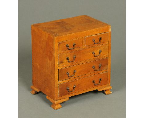 An apprentice piece walnut chest of drawers, two short and three long, raised on bracket feet.  Width 18.5 cm. 
