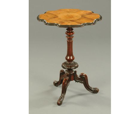 A Victorian walnut and rosewood shaped tripod table, with turned column and three downswept legs terminating in scroll feet. 