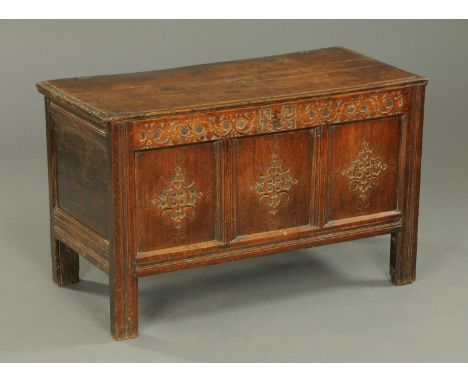 A late 17th century Trough of Bowland oak coffer, dated 1695, with carved panelled front and raised on stile feet.  Width 118