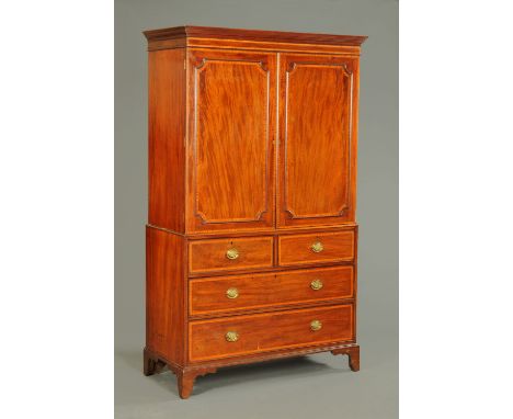 A George III inlaid mahogany linen press, with moulded detachable cornice above a pair of panelled cupboard doors opening to 