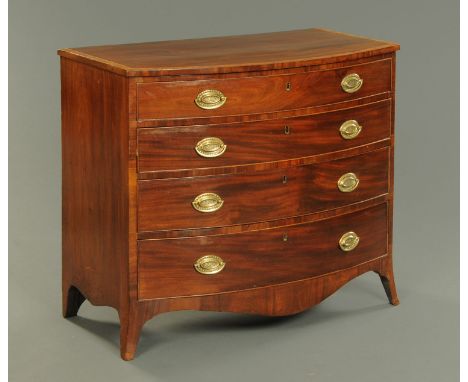 A George III mahogany and tulip wood crossbanded bowfronted chest of drawers, with four long graduated drawers with brass dro