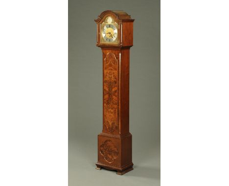 An Elliott of London walnut grandmother clock, with three-train movement striking on eight gongs (see illustration).