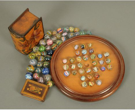 A collection of 71 handmade marbles, a solitaire board, playing card casket and small wooden box. 