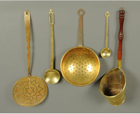 A Victorian brass ladle, spoon, grain scoop and two skims.