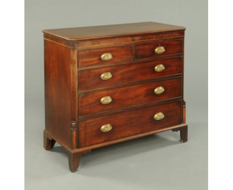 A George III mahogany chest of drawers, the rectangular top with moulded edge and canted angles above two short and three lon