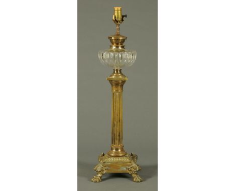 A Victorian brass column oil lamp, with reeded column, stepped base and raised on paw feet.  Height excluding light fitting 6