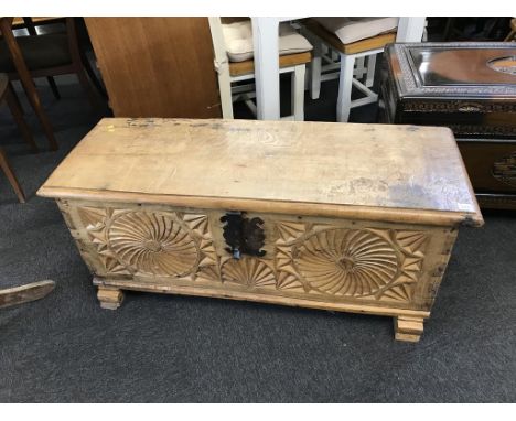 A Continental light oak carved coffer