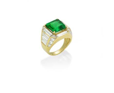 GARRARD: EMERALD AND DIAMOND RINGThe step-cut emerald within a surround of tapered baguette and triangular-cut diamonds, betw