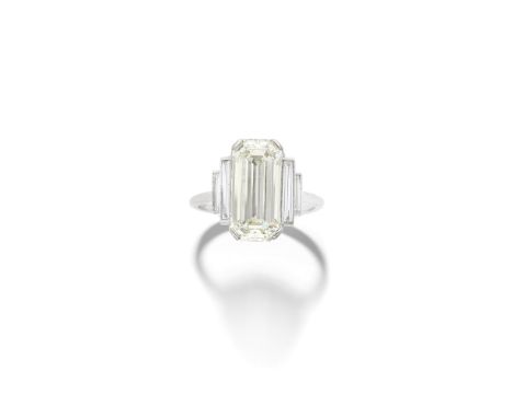 DIAMOND RINGThe elongated step-cut diamond, weighing 5.03 carats, between stepped baguette-cut diamond shoulders,  remaining 
