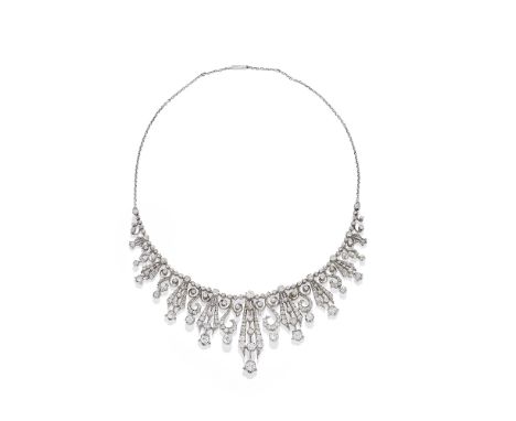 DIAMOND FRINGE NECKLACE, CIRCA 1890The articulated chain, suspending an articulated knifewire fringe set with cushion-shaped 
