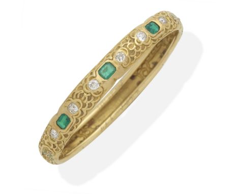 ATTRIBUTED TO TIFFANY: ART NOUVEAU EMERALD AND DIAMOND BANGLE, CIRCA 1884Chased throughout with cloud motifs, and green ename