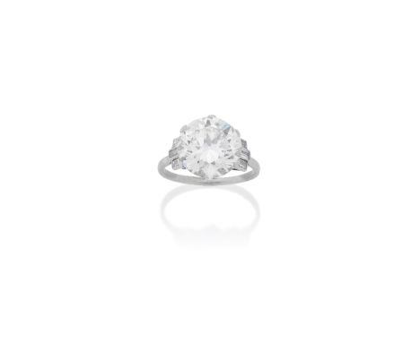 DIAMOND SINGLE-STONE RINGThe old brilliant-cut diamond, weighing 6.48 carats, between baguette-cut diamond shoulders,  ring s