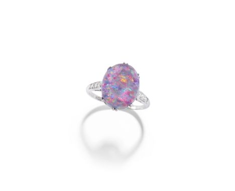 OPAL AND DIAMOND RING, FIRST HALF OF THE 20TH CENTURYThe oval opal between single-cut diamond shoulders, hoop stamped WG&amp;