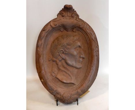 A stone plaque with portrait of a Greek figure, 66 x 43cm 