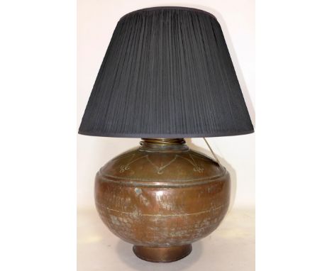 An early 20th century copper vase converted to a lamp 