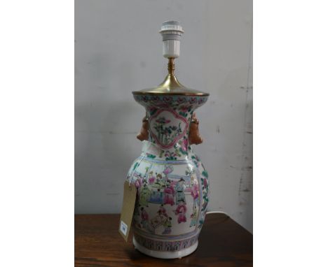 A late 19th century famille rose baluster vase converted to a lamp, decorated with vignettes of figures in courtyard scenes, 