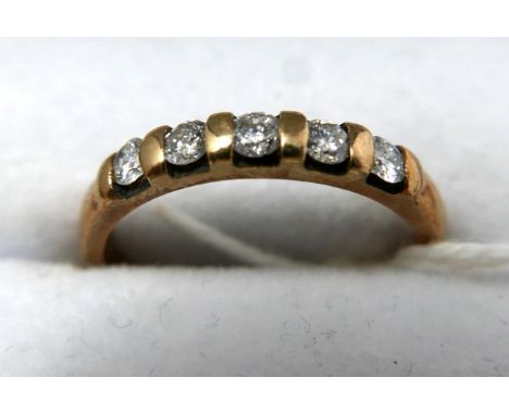 A 9ct yellow gold ring set with five diamonds, 0.33 carats, 2.2 grams 