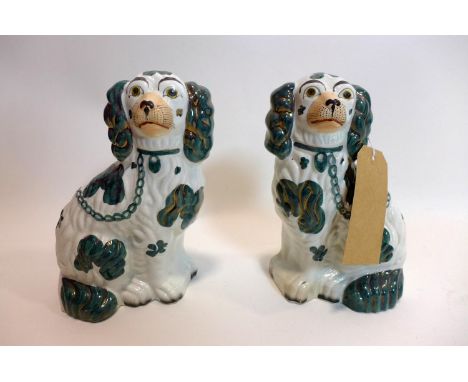 A pair of late 19th century ceramic Staffordshire dogs with green, white and gold detailing, number 2 stamped to each base 15