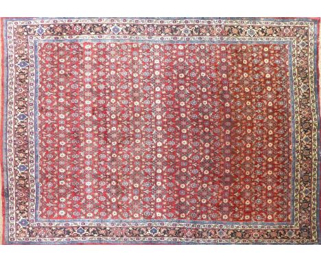 A North West Persian Bidjar carpet, repeating herati and rosette motifs on a terracotta field, within stylised floral border,