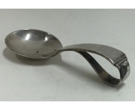 GEORG JENSEN: A silver caddy spoon of typical design bearing import marks. Approx. 28 grams. Est. £50 - £80.