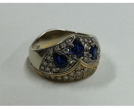 A large 18 carat gold sapphire and diamond dress ring. Approx. 8.5 grams. Est. £500 - £600.