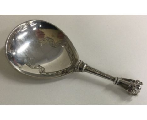 An unsual Continental silver caddy spoon engraved with scrolls. Approx. 35 grams. Est. £30 - £40.