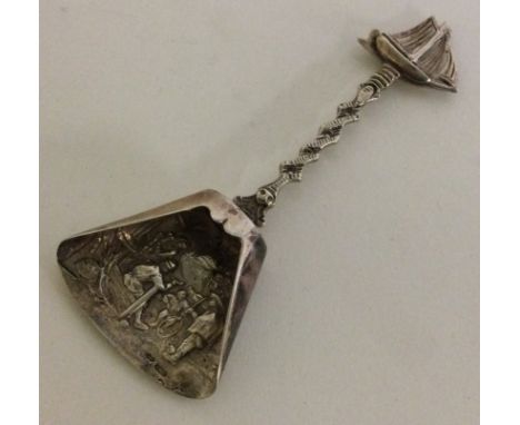 A novelty Continental silver caddy spoon in the form of a shovel decorated with cast ship to handle. Approx. 19 grams. Est. £