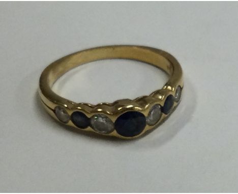 An 18 carat gold sapphire and diamond seven stone half hoop ring. Approx. 2.9 grams. Est. £200 - £250.