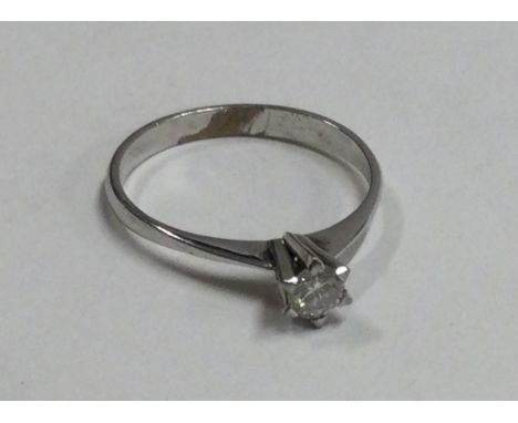A small diamond single stone ring in 14 carat gold. Est. £120 - £150.