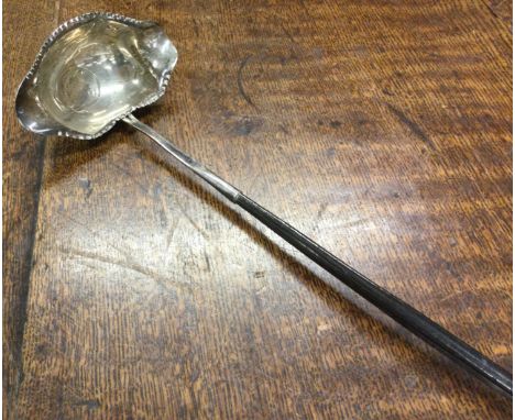A 19th Century silver toddy ladle with coin centre. Approx. 42 grams. Est. £200 - £300.