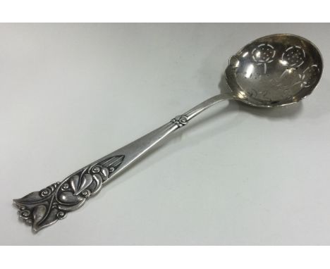 A large silver ladle with pierced and chased handle. Approx. 79 grams. Est. £50 - £80.