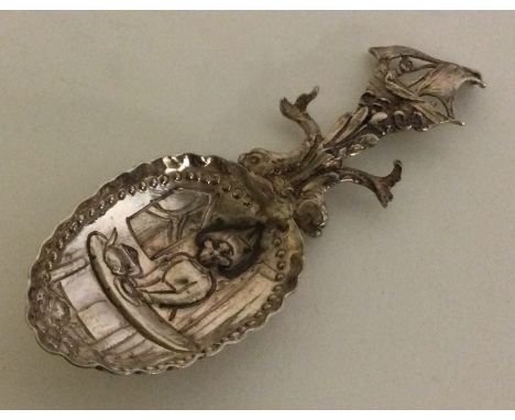 A heavy Continental silver embossed caddy spoon cast with serpents and ship. Approx. 29 grams. Est. £30 - £50.