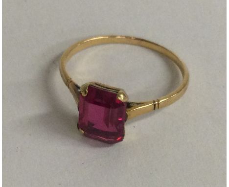 A small 9 carat and red stone ring. Approx. 2 grams. Est. £20 - £30.