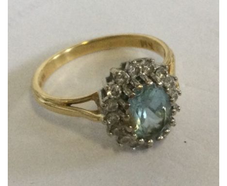 A good 18 carat gold aquamarine and diamond oval cluster ring. Approx. 4 grams. Est. £200 - £300.