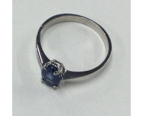 A small blue stone ring in white gold claw mount. Approx. 1.8 grams. Est. £50 - £80.