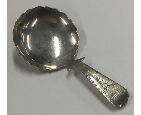A large George III silver caddy spoon with bright cut decoration to handle and border. London 1813. By Thomas James. Approx. 