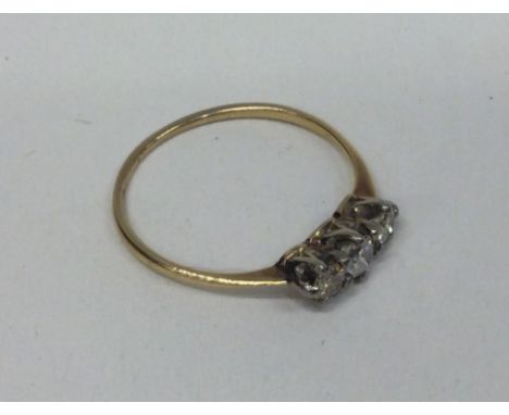 A good diamond three stone ring in two colour gold setting. Approx. 1.5 grams. Est. £50 - £80.