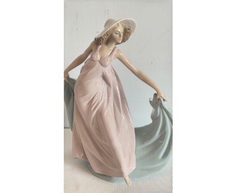 Lladro porcelain figurine, made in Spain, model number 5663, dated 1989, depicts a woman in a flowing dress with a hat.