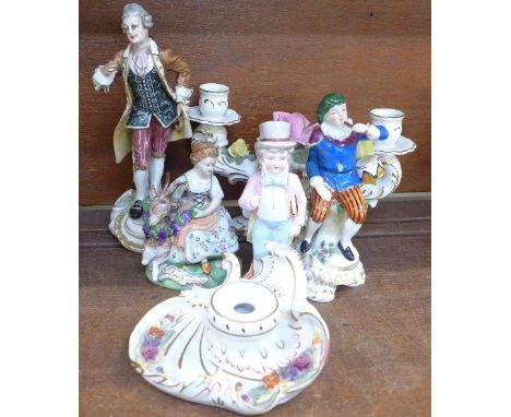 Four Staffordshire and continental figures including a bisque figure, a Dresden candlestick and an inkwell, (6), some a/f