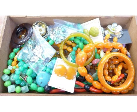 A box of vintage plastic, Bakelite and lucite jewellery