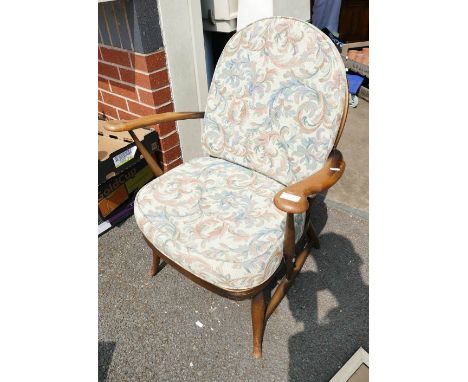 A mid-century elm Ercol Fleur de Lis arm chair