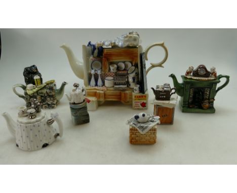 A collection of Cardew type novelty type tea pots to include The Pottery Market Stall, Fireplace, Teapot, Tea Chest, etc. (6)