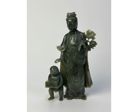 A carved spinach jade Guanyin and child groupChina, Qing Dynasty (1644 - 1912), Guangxu (1875 - 1908)Provenance: French trade