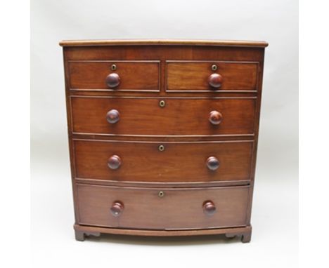 A 19TH CENTURY MAHOGANY BOW FRONTED CHEST of two short over three long graduated drawers with knob handles, on bracket feet 