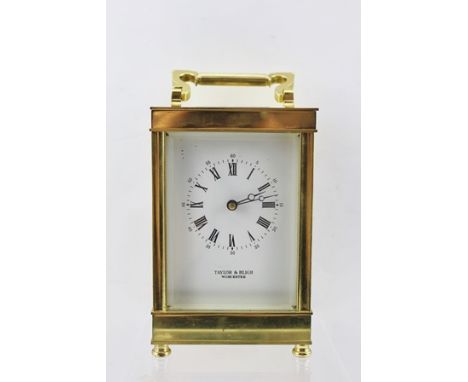 A 20TH CENTURY BRASS CASED CARRIAGE CLOCK, with hinged bale handle, the white enamel dial with Roman numerals, inscribed "Tay